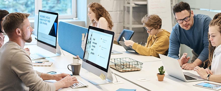 Operations team monitoring systems across multiple screens